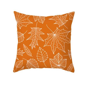 Orange autumn pillow cover with white maple leaf pattern on clean white background