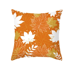 Orange autumn pillow cover featuring maple leaves and golden sequins on a white background