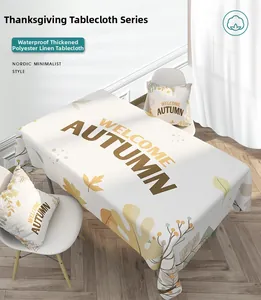 Close-up of waterproof linen tablecloth featuring Welcome Autumn text and fallen leaves