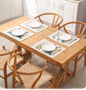 Linen placemat set with deer and geometric patterns on a wooden table with plates
