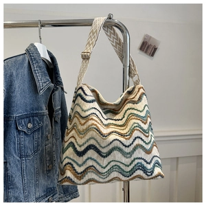 Close-up of bohemian woven tote bag with wavy patterns and jacquard shoulder strap