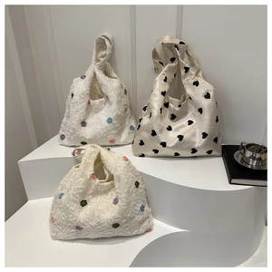 Three minimalist nylon and satin shoulder bags with floral and heart patterns