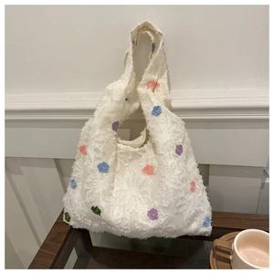 Detailed view of white floral knit tote bag featuring soft 3D jacquard texture and colorful dots
