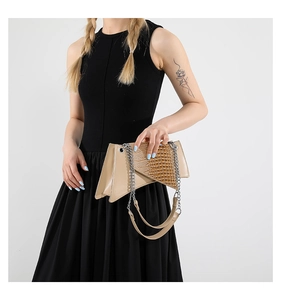 Close-up of geometric mini chain bag featuring brown crocodile pattern and silver metal hardware