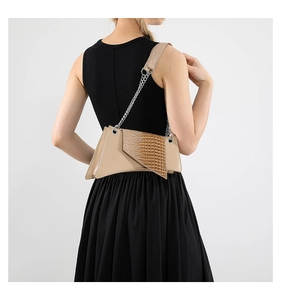 Detail view of beige crossbody bag with crocodile embossed leather and chain strap