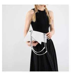 White geometric shoulder bag with crocodile pattern and silver chain shown on model
