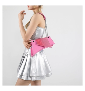Close-up of pink geometric crossbody bag with crocodile texture and silver chain strap