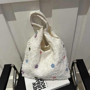 Chic white knit tote bag with colorful 3D floral embroidery and soft tufted texture