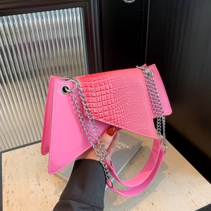 Pink asymmetrical crossbody bag with faux crocodile texture and silver metal chain strap