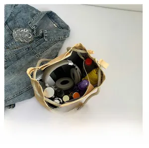 Top view of beige quilted tote bag showing large capacity with personal items and woven handles