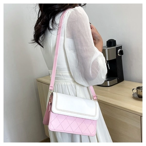 Detail of pink and white crossbody bag with quilted pattern and elegant V-shaped stitching