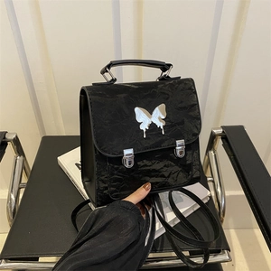 Black ruched mini backpack with silver butterfly ornament and metal buckle closure