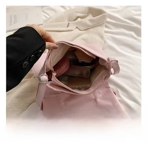 Top view of pink crossbody bag interior showing storage capacity for daily essentials