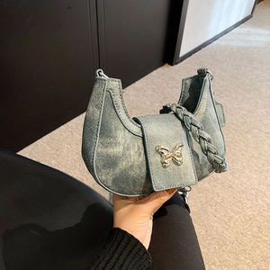 Denim crescent shoulder bag with woven strap and silver butterfly accent for women