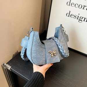 Light blue denim hobo bag with metal butterfly buckle and woven shoulder strap