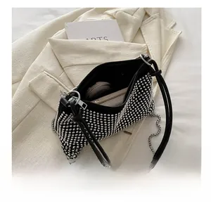 Detail of a chic rhinestone underarm bag showing interior capacity for essentials