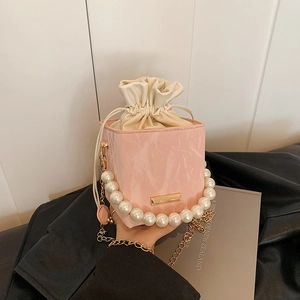 Pink pearl-handle box bucket bag with gold chain strap and drawstring closure