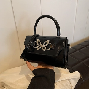 Glossy black patent leather handbag with silver butterfly buckle and thin shoulder strap