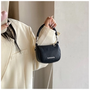Détail du mini sac en cuir grainé noir avec clous étoiles argentés et bandoulière