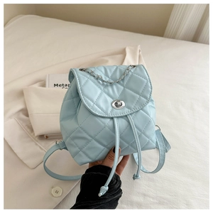 Macro shot of light blue quilted mini backpack with silver chain and twist lock detail