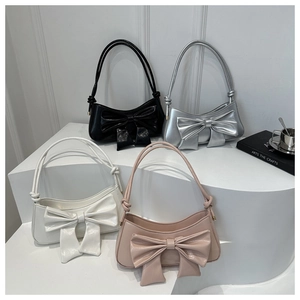 Bow tie shoulder bag in glossy patent leather available in black silver white and pink