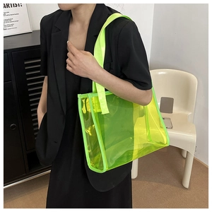 Detail of neon green transparent PVC tote bag with reinforced strap stitching and texture