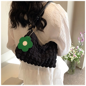 Black bubble texture crossbody bag with green flower charm for women daily wear