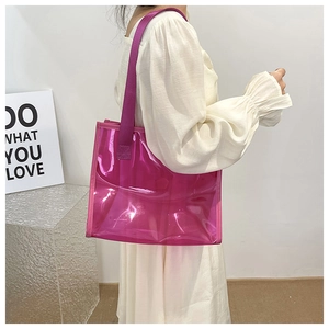 Detailed view of magenta translucent PVC tote bag with stylish wide shoulder strap