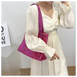 Detail of rose red translucent PVC tote bag with matching wide fabric shoulder strap