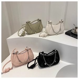 Détail de sacs à main à texture marbrée avec chaînes métalliques et bandoulières nouées