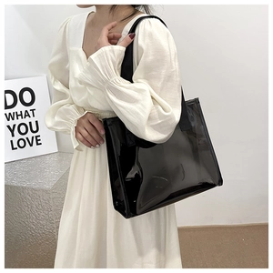 Close-up of black transparent PVC tote bag with wide straps for travel and daily use