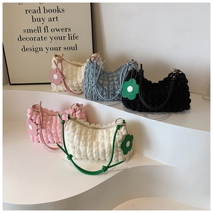Detail of multi-colored bubble texture bags with floral pendants on tiered display