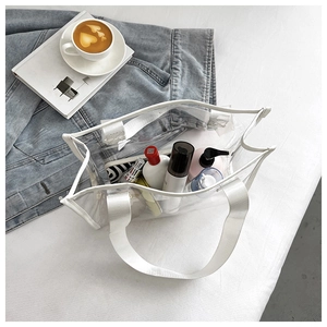 Detailed view of large transparent PVC tote bag holding skincare essentials and toiletries