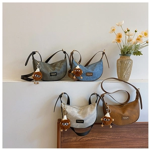 Chic crescent bags in four colors featuring fashion label and plush monster charm