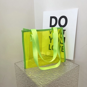 Transparent neon yellow PVC tote bag with stylish nylon handles for summer beach travel
