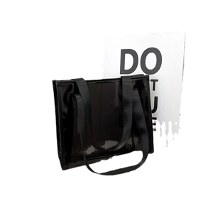 Minimalist black transparent PVC tote bag with durable nylon handles for travel