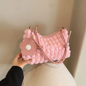 Pink popcorn textured pleated shoulder bag with floral charm and gold metal hardware