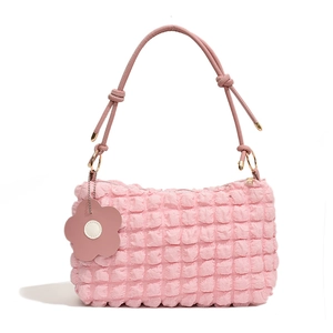 Pink quilted bubble hobo bag with knotted leather strap and flower pendant detail
