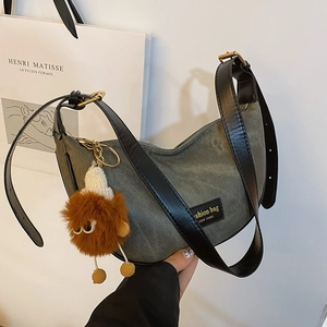 Army green denim canvas hobo bag with leather strap and plush monster pendant