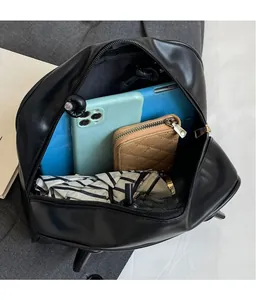 Interior view of large capacity black tote bag showing organized storage for gadgets and umbrella