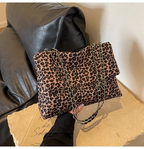Détail du sac léopard avec bandoulière en chaîne dorée et tissu à texture raffinée