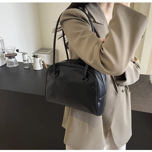 Classic black PU leather Boston shoulder bag styled with a professional blazer for workwear