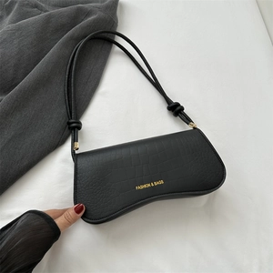 Minimalist black faux crocodile underarm bag with gold logo and knotted strap