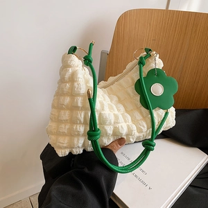 Quilted bubble texture shoulder bag with green rope strap and flower charm accessory
