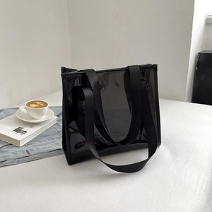 Minimalist black translucent PVC tote bag with wide nylon handles in lifestyle setting
