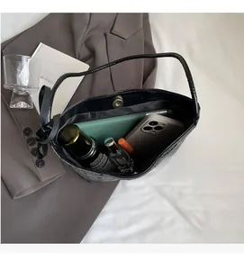 Internal view of spacious polka dot bucket bag with smartphones and cosmetics