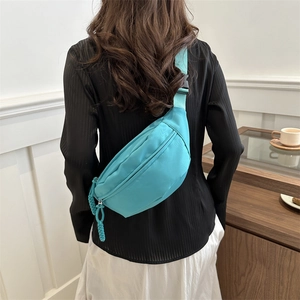 Minimalist tiffany blue nylon crossbody chest bag for women on a model back view