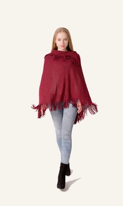 Detail of red and black knit poncho sweater with fringe hem and elegant lapel collar