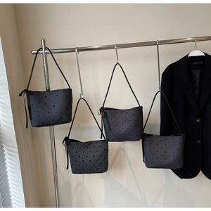 Detail display of four canvas tote bags with star, heart, bow, and dot patterns