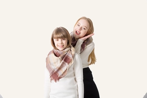 Detail of soft plaid cashmere-feel triangle scarves for parent and child with tassels
